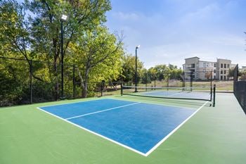The preserve at ballantyne commons tennis court with apartments in the background